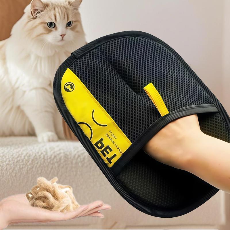Black and yellow reusable pet hair removal mitt shown on a hand beside a cat